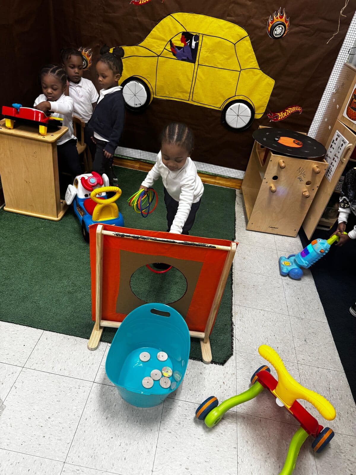 Toddlers exploring toys and activities in the play area