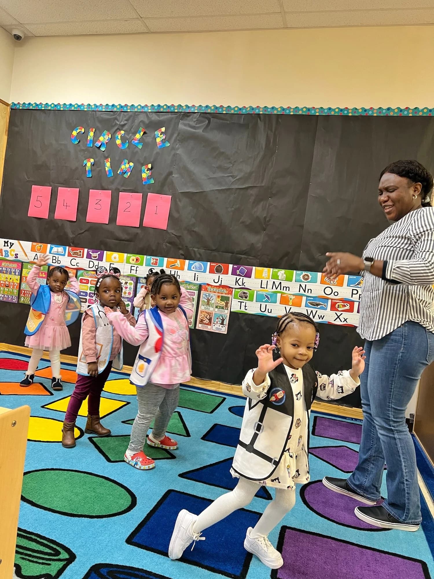 Children participating in music and movement activities at Einstein Daycare preschool in East Flatbush Brooklyn