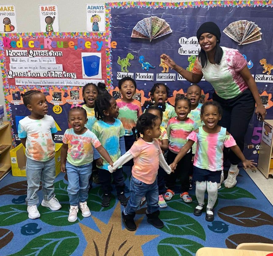 Preschool teacher with students in the Einstein Daycare pre-K classroom